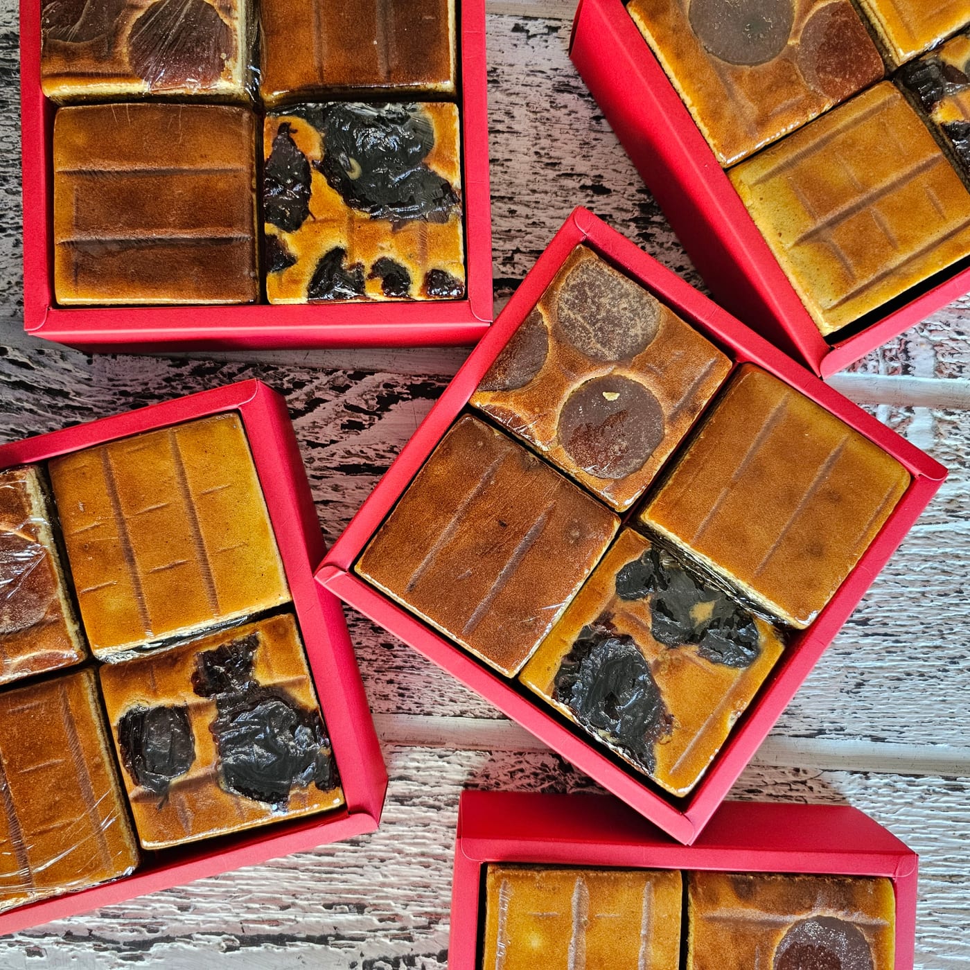 Assorted lapis legit pieces packed in red gift boxes